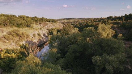 Aerial shot of canyon with river during sunny day