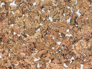 Decorative cork panel for facing cladding. Wooden brown background.