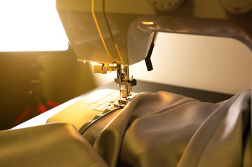 Sewing machine and beautiful grey cloth. Fashion concept. Hobby ideas.
