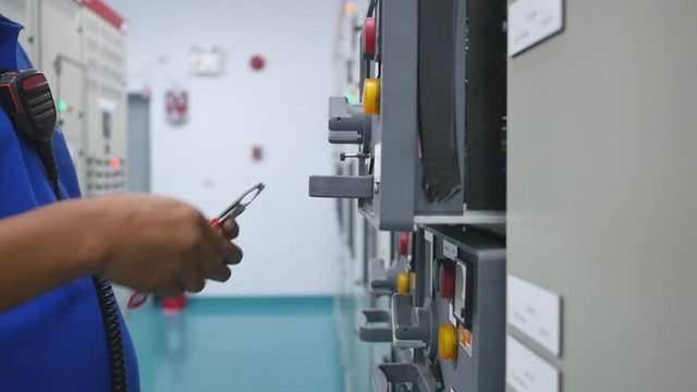 Engineer to use key lock out tag out (LOTO) for isolated power electrical system before maintenance equipment in factory , Safety and industrial concept