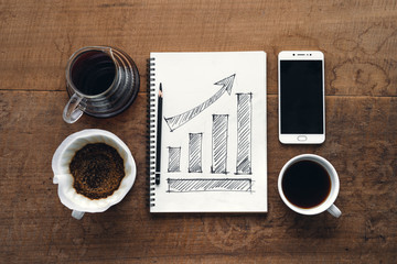 Business Growth Draw graph in book In the morning,smartphone and coffee