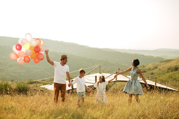 Happy family in nature. Happy family: mother, father, children son and daughter. life is made of little things.