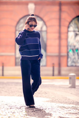 Asian girl in purple sweater walks on the street