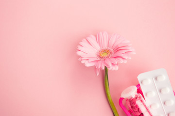 Women's health, medicine and healthcare concept. Pink tablets in a glass bottle, blister and...