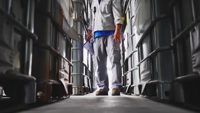 Engineer to check quality and quantity of chemical tank in warehouse, Industrial and chemical plant concept