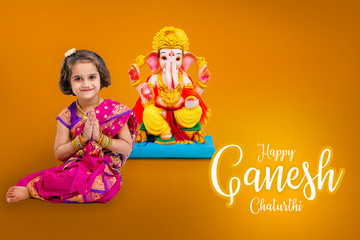 Little indian girl with lord ganesha, Indian ganesh festival