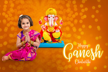 Little indian girl with lord ganesha, Indian ganesh festival