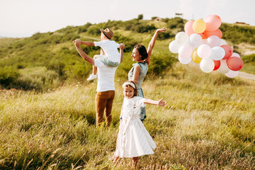 Happy family in nature. Happy family: mother, father, children son and daughter. life is made of little things.
