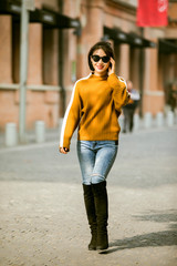 Asian girl in yellow sweater on the street in Shanghai