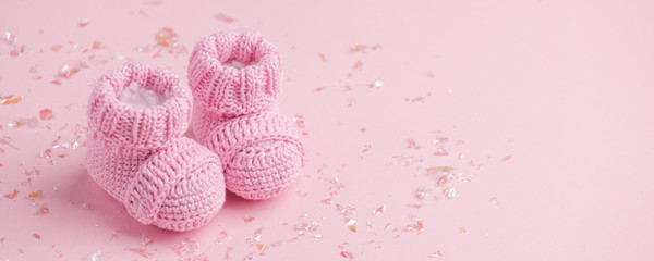 Pair of small baby socks on pink background with copy space for your warm message, baby shower, first newborn party background, copy space, cute minimal postcard - 286098522