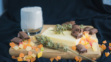 Preparing to cooking cake with cannabis butter. Concept of using marijuana in food industry.