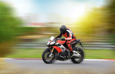 Motorcycle rider racing at high speed on a colorful background