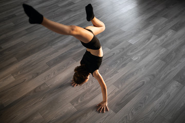 Beautiful girl practicing and exercising modern ballet at dance school