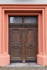 wooden door with a beautiful wooden ornament in the historical part of the German city of Mainz