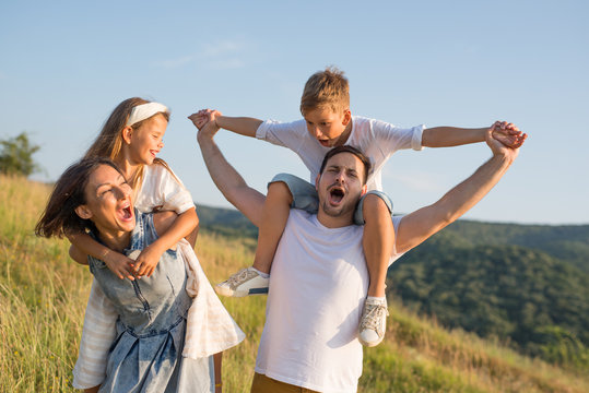 Happy family in nature. Happy family: mother, father, children son and daughter. life is made of little things.