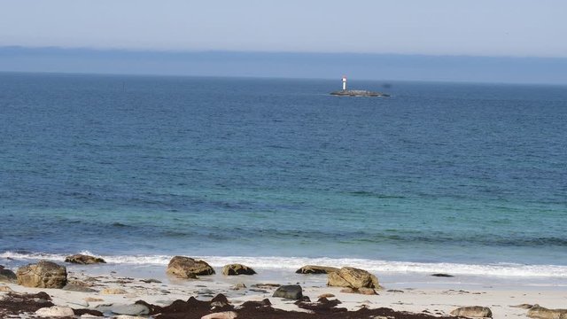 Seascape with lighthouse on rocky isle. Andoya island village Bleik. Vesteralen archipelago, Norway