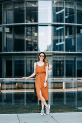  stylish image in the modern architecture of the building. a bright young girl in Berlin. © pavelvozmischev