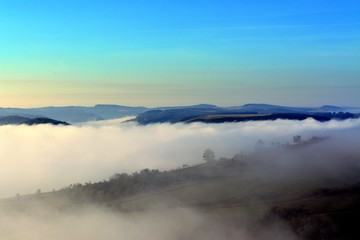 fog between hills in the morning