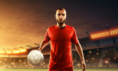Professional soccer player in sports uniform with a ball in his hands