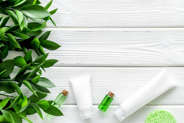skin care with natural cosmetics with herbal extract on white wooden background top view mockup