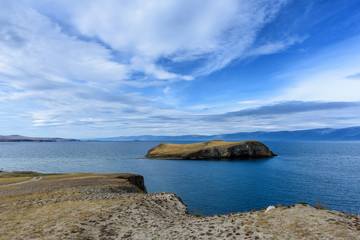 Fototapeta na wymiar Lake Baikal and mountains of Siberia with beautiful sky and clouds, Russia Oklhon island