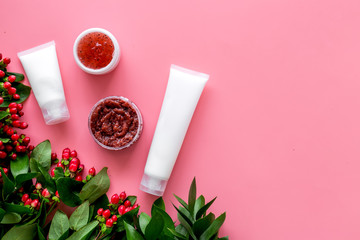 homemade spa with cosmetic from herbs and berrries on pink background top view space for text