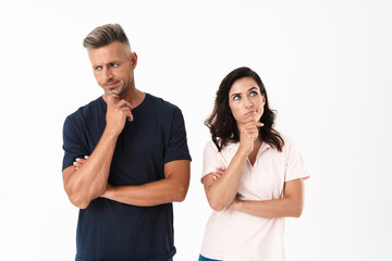 Pensive attractive couple wearing casual outfit standing