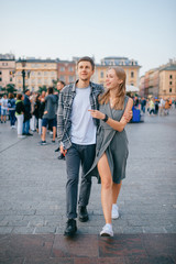 Fototapeta Happy loving couple smiling and walking throug the main square in Krakow (Cracow) obraz