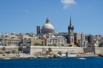 Fototapeta na wymiar The stunning skyline of old Valletta with its churches and towers, ramparts and historic mansions from the Northern Harbour, Malta.