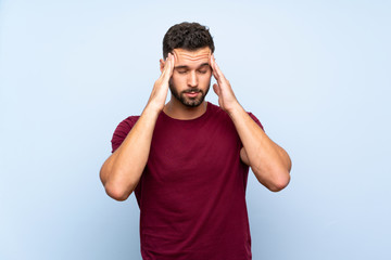 Fototapeta premium Handsome man over isolated blue background with headache