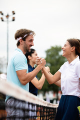 Fit happy poeple playing tennis together. Sport concept