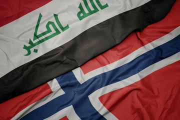 waving colorful flag of norway and national flag of iraq.