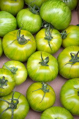Green Tomatoes in Box on Market