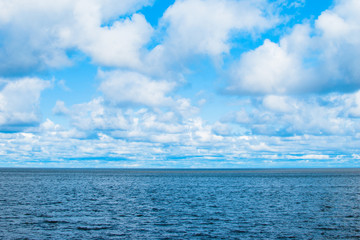 Obraz premium Blue lake surface with clouds.
