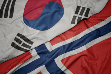 waving colorful flag of norway and national flag of south korea.