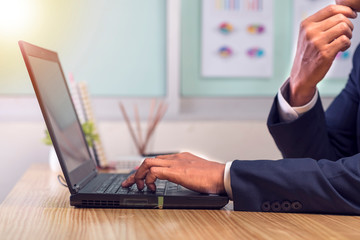 Asian businessman hands on the keyboard Working at home office with laptop,Data Processing business concept.