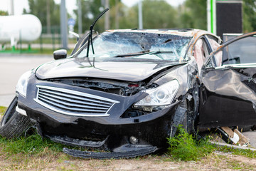 Wrecked car on side of highway. Safety on road. Accident or crash.
