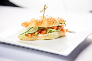 croissant with salmon on a white background