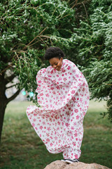 Portrait of african american young model wearing traditional dress with smiling face at nature