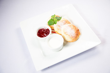 cottage cheese with sour cream and jam on a white background