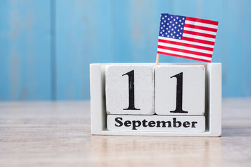 11 September calendar (9/11) with United States of America flag on wood background. copy space for text. Patriot Day and Memorial concept