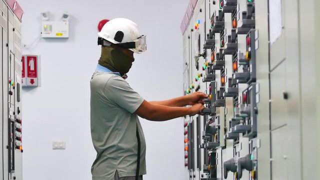 Maintenance Technician to check electrical device in Electricity substation building in industrial plant. Industrial and technology concept