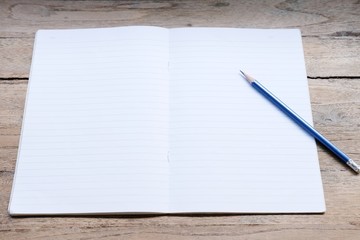 notebook and pen on wooden background