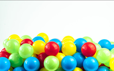 Colored plastic balls in pool of game room. Dry Swimming pool for fun and jumping in colored plastic balls. The concept of celebration and fun