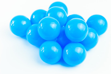 Isolate blue plastic balls in pool of game room. Dry Swimming pool for fun and jumping in  plastic balls. The concept of celebration and fun