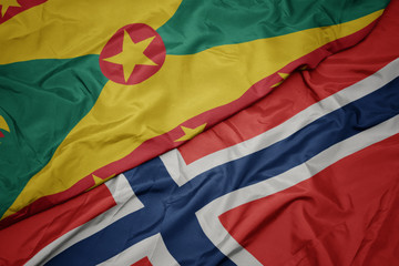 waving colorful flag of norway and national flag of grenada.