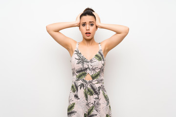 Fototapeta premium Young woman over isolated white background frustrated and takes hands on head