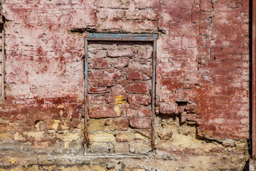 Old wall of destroyed house. Old powder wall with walled window and gates, doors. Ruined house. Remains of old houses. Apocalypse Abandoned city Broken building. Effects of earthquake, economic crisis