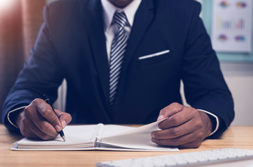 Asian businessman checklist and writer at work table,office desk background,Concept to checklist.