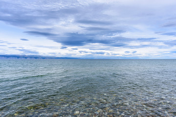 Lake Baikal and mountains of Siberia with beautiful sky and clouds, Russia Oklhon island